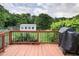 View of the deck and the surrounding backyard and greenery and shed beyond at 3627 Nc 57, Hillsborough, NC 27278
