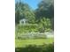 Thriving vegetable garden with raised garden beds and lush greenery, complemented by a quaint shed at 3627 Nc 57, Hillsborough, NC 27278