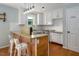 Bright kitchen boasts modern appliances, white cabinets, granite countertops, and a breakfast bar at 3627 Nc 57, Hillsborough, NC 27278