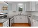 Well-equipped kitchen with granite countertops, a stainless steel dishwasher, and natural light at 3627 Nc 57, Hillsborough, NC 27278