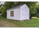 Exterior view of a storage shed with double doors and colorful quilt at 3627 Nc 57, Hillsborough, NC 27278