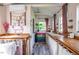 Shed interior with work spaces, windows with pink curtains and a small comfortable seating area at 3627 Nc 57, Hillsborough, NC 27278