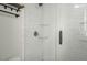 White tile shower with glass door and shelves at 3627 Nc 57, Hillsborough, NC 27278