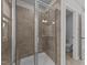 Glass shower featuring tiled walls, a built-in seat, with view into a separate toilet room at 380 Garden Vine Trl, Raleigh, NC 27610