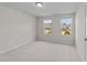 Bright carpeted bedroom with plenty of natural light from two windows overlooking the neighborhood at 380 Garden Vine Trl, Raleigh, NC 27610