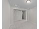 Well-lit bedroom with neutral walls and carpet, featuring access to other rooms at 380 Garden Vine Trl, Raleigh, NC 27610