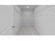 Walk-in closet featuring metal shelving, carpeted floors and neutral paint at 380 Garden Vine Trl, Raleigh, NC 27610