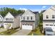 Charming two-story home featuring stone accents, a two-car garage, and manicured landscaping at 380 Garden Vine Trl, Raleigh, NC 27610