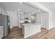 Open kitchen design with a large island, stainless steel appliances, and white countertops at 380 Garden Vine Trl, Raleigh, NC 27610