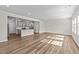 Open-concept living room and kitchen with hardwood floors and recessed lighting at 380 Garden Vine Trl, Raleigh, NC 27610