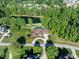 Aerial view of an estate featuring a large in-ground pool, luxurious landscaping, and perfectly manicured lawn at 3829 Westbury Lake Dr, Raleigh, NC 27603