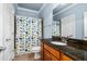 A bathroom offers a modern vanity with sink, granite countertop, and shower with tub at 3829 Westbury Lake Dr, Raleigh, NC 27603