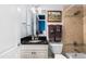 A bathroom offers a single sink vanity, framed mirror, and a tiled shower with tub at 3829 Westbury Lake Dr, Raleigh, NC 27603
