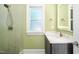 Bright bathroom features a stylish vanity with marble counters, a modern mirror, and walk-in shower with beautiful tile work at 3829 Westbury Lake Dr, Raleigh, NC 27603