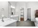 Bright bathroom with double vanities, modern fixtures, and an open doorway to the walk-in closet at 3829 Westbury Lake Dr, Raleigh, NC 27603