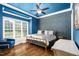 A beautifully decorated bedroom features trey ceilings, hardwood floors, and a large window at 3829 Westbury Lake Dr, Raleigh, NC 27603