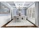 Elegant dining room featuring wainscoting, coffered ceilings, chandelier, and ample natural light at 3829 Westbury Lake Dr, Raleigh, NC 27603