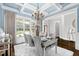Chic dining room with mirrored table, stylish chairs, soft rug, and bright light at 3829 Westbury Lake Dr, Raleigh, NC 27603