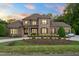 Beautiful brick home with a well-manicured lawn, elegant landscaping, and a circular driveway for stunning curb appeal at 3829 Westbury Lake Dr, Raleigh, NC 27603