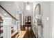 Grand foyer with high ceilings, hardwood floors, elegant lighting, and front door at 3829 Westbury Lake Dr, Raleigh, NC 27603