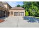 Side-entry four-car garage with three garage doors and basketball hoop, sitting on a large concrete driveway at 3829 Westbury Lake Dr, Raleigh, NC 27603