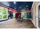 A home gym features ample workout space, mirrors, large windows, and custom storage at 3829 Westbury Lake Dr, Raleigh, NC 27603