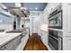 High-end kitchen showcases stainless steel appliances, including double ovens and a spacious island with cooktop at 3829 Westbury Lake Dr, Raleigh, NC 27603