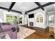 Inviting living room with fireplace, hardwood floors, beamed ceilings, and access to the veranda at 3829 Westbury Lake Dr, Raleigh, NC 27603