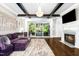 Inviting living room with fireplace, hardwood floors, beamed ceilings, and access to the veranda at 3829 Westbury Lake Dr, Raleigh, NC 27603