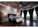 Luxurious main bedroom suite featuring a tray ceiling, elegant decor, and large windows at 3829 Westbury Lake Dr, Raleigh, NC 27603