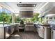 Outdoor kitchen featuring stainless steel appliances, custom cabinetry, and a granite countertop at 3829 Westbury Lake Dr, Raleigh, NC 27603
