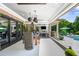 Outdoor living space with dining area, fireplace, and pool views at 3829 Westbury Lake Dr, Raleigh, NC 27603