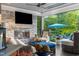 Outdoor living space with plush seating, a stone fireplace, and a view of the lake at 3829 Westbury Lake Dr, Raleigh, NC 27603