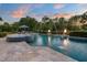 Outdoor swimming pool features water fountains, nearby fire pits, and an umbrella-covered lounge area with seating at 3829 Westbury Lake Dr, Raleigh, NC 27603