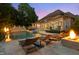 A luxury backyard features an in-ground pool, jacuzzi, sun loungers, and a fire pit, perfect for relaxing at night at 3829 Westbury Lake Dr, Raleigh, NC 27603