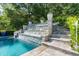 A luxury swimming pool with a waterslide and a stacked stone water feature creates a resort-like retreat at 3829 Westbury Lake Dr, Raleigh, NC 27603