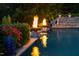 Outdoor pool features water fountains, a waterslide, nearby fire pits, and lush greenery for private relaxation at 3829 Westbury Lake Dr, Raleigh, NC 27603