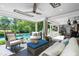 Relaxing veranda featuring comfortable seating, ceiling fan, and view of the pool and backyard at 3829 Westbury Lake Dr, Raleigh, NC 27603