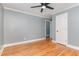 Bedroom featuring hardwood floors, gray walls, white trim, and a view of a door to another room at 4420 W River Rd, Franklinton, NC 27525