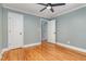 Bedroom features hardwood floors, a ceiling fan, neutral paint, and white doors at 4420 W River Rd, Franklinton, NC 27525