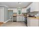 Well-lit kitchen featuring white cabinets, butcher block countertops, and stainless steel appliances at 4420 W River Rd, Franklinton, NC 27525