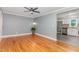 Bright open-concept room featuring hardwood floors, gray walls, and a view into the adjacent white kitchen at 4420 W River Rd, Franklinton, NC 27525