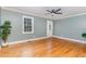Living room featuring hardwood floors, cool gray walls, white trim, and a view of a window and the front door at 4420 W River Rd, Franklinton, NC 27525