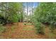 Private backyard surrounded by lush greenery and mature trees at 4953 Tuckahoe Trce, Wake Forest, NC 27587