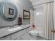 Bathroom featuring a granite countertop vanity with sink, toilet, and shower/tub combo with white curtains at 4953 Tuckahoe Trce, Wake Forest, NC 27587