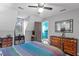 Bedroom featuring a ceiling fan, wooden dressers, and a colorful striped comforter on the bed at 4953 Tuckahoe Trce, Wake Forest, NC 27587
