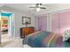 Bright bedroom with colorful bedding and gray walls with view of attached hallway at 4953 Tuckahoe Trce, Wake Forest, NC 27587