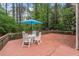 Outdoor deck with patio seating and a vibrant blue umbrella at 4953 Tuckahoe Trce, Wake Forest, NC 27587