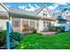 Charming backyard featuring a screened-in porch, well-maintained lawn, and tasteful landscaping at 5045 Homeplace Dr, Apex, NC 27539