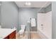 Bright bathroom featuring a white tub-shower combo and white fixtures, providing a fresh and functional space at 5045 Homeplace Dr, Apex, NC 27539